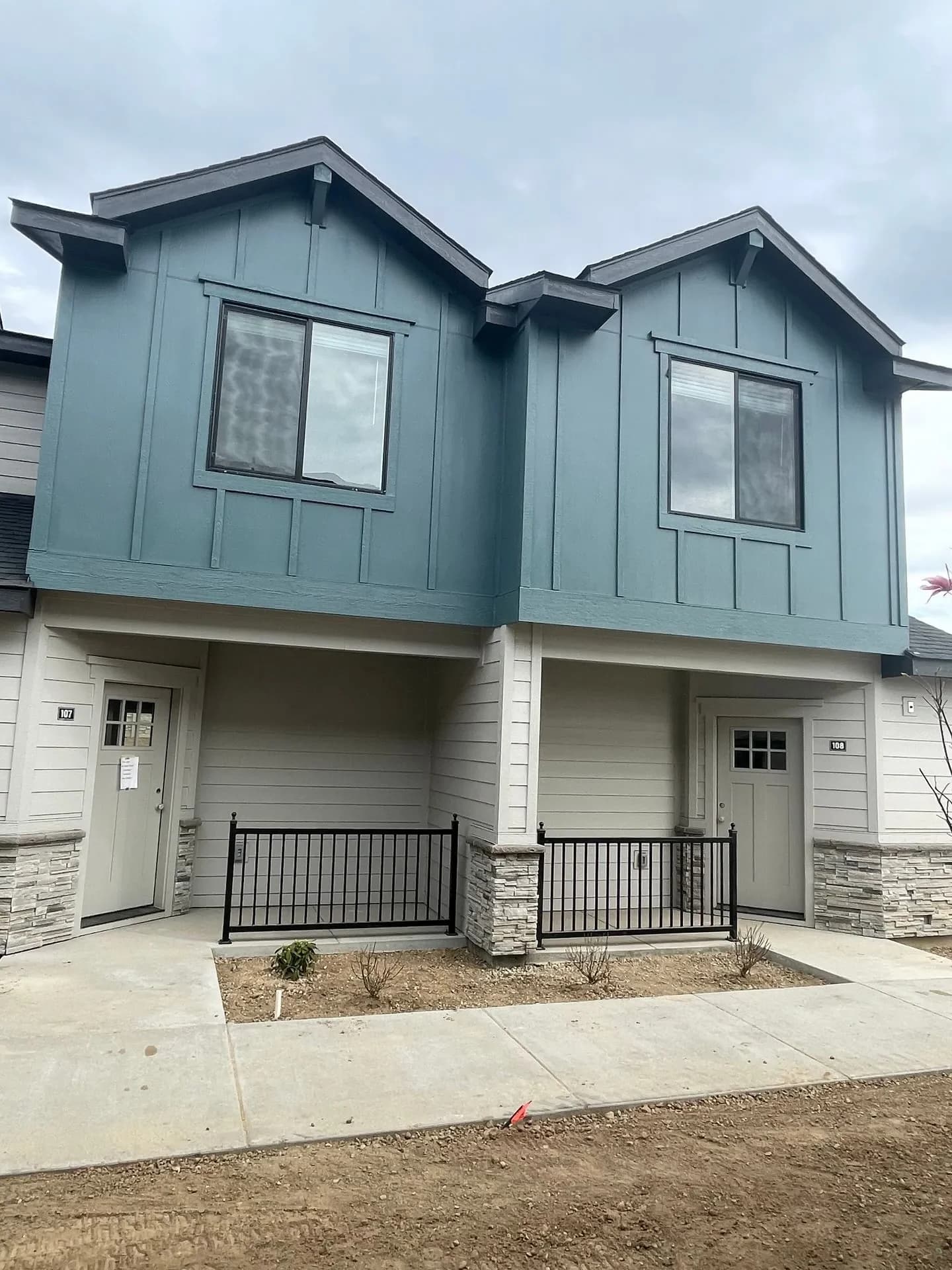 Craftsman-style townhome entrances with covered porches and modern siding at Eagle Villa in Boise