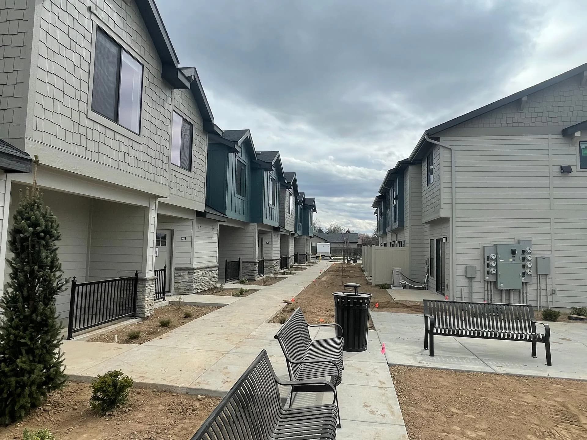 Paved walkways and landscaping between luxury townhome buildings at Eagle Villa in Boise